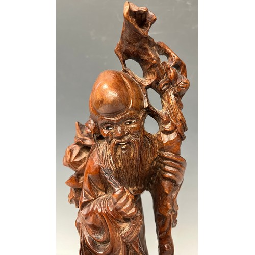 933 - A Japanese root carving, wise elder with crane at his feet, 30cm, hardwood base, c.1900