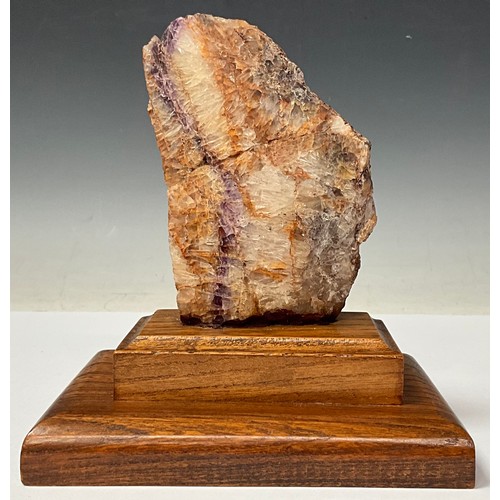 175 - A Derbyshire Blue John specimen section, part polished, 13cm, mounted on an oak plinth base