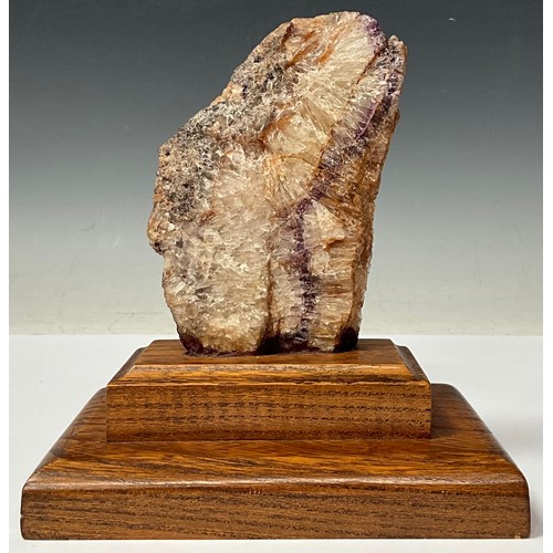 175 - A Derbyshire Blue John specimen section, part polished, 13cm, mounted on an oak plinth base