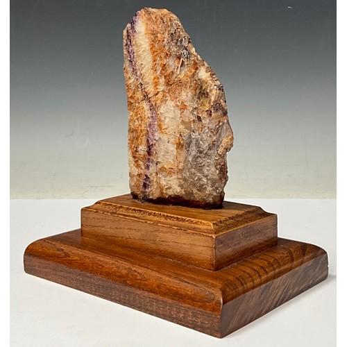 175 - A Derbyshire Blue John specimen section, part polished, 13cm, mounted on an oak plinth base