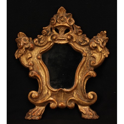 1007 - A Baroque giltwood looking glass, cartouche shaped mirror plate, the frame pierced and carved with f... 