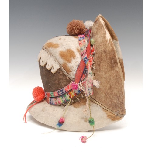 15 - Tribal Art - a Bolivian Montera, ceremonial cowhide helmet of a Tinku dancer, 29cm high