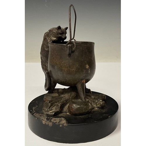 965 - A 19th century Continental bronze, of a cat peering into a cauldron, circular black slate base, 10cm... 