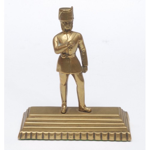 A Victorian brass desk weight, as an Hussar wearing a busby fur hat, he