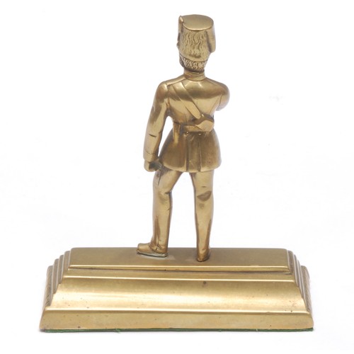 A Victorian brass desk weight, as an Hussar wearing a busby fur hat, he