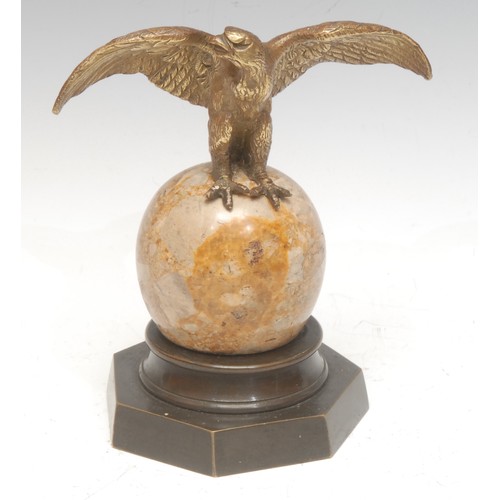 963 - A 19th century Continental bronze, as an eagle, perched on an onyx sphere, brass heptagonal base, 15... 