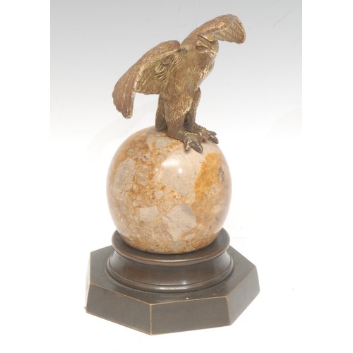 963 - A 19th century Continental bronze, as an eagle, perched on an onyx sphere, brass heptagonal base, 15... 