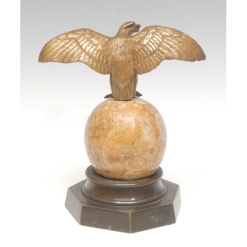 963 - A 19th century Continental bronze, as an eagle, perched on an onyx sphere, brass heptagonal base, 15... 