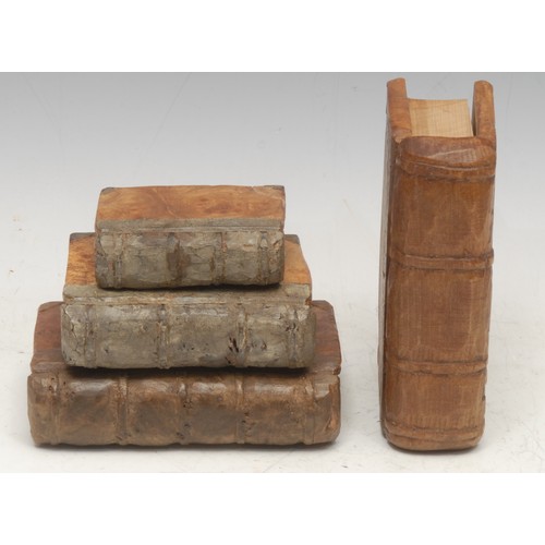 915 - Treen and Modern Design - a set of mid-century walnut carvings, as leather-bound books, the largest ... 