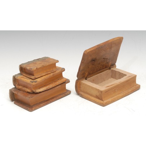 915 - Treen and Modern Design - a set of mid-century walnut carvings, as leather-bound books, the largest ... 