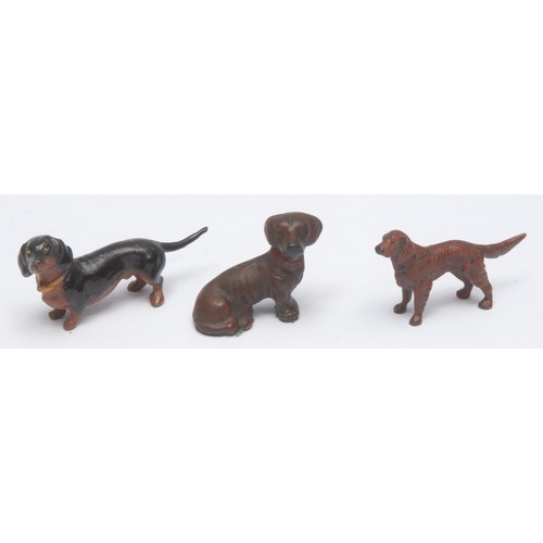 969 - A 19th century Viennese cold-painted bronze dog, a retriever, 3.5cm high; two others similar, as a c... 