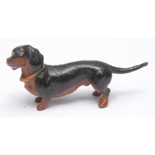 969 - A 19th century Viennese cold-painted bronze dog, a retriever, 3.5cm high; two others similar, as a c... 