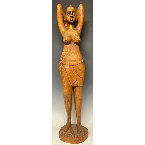 69 - Tribal Art - a North African carved wooden figure, of a woman parting her hair, circular base, 66cm ... 