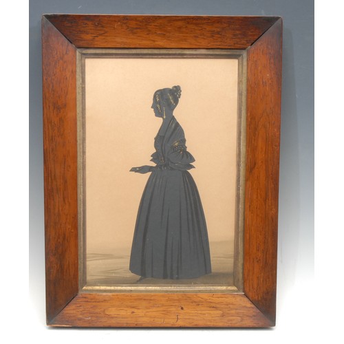 269 - An Edwardian full-length silhouette, of a lady wearing a ball gown and holding an invitation, facing... 