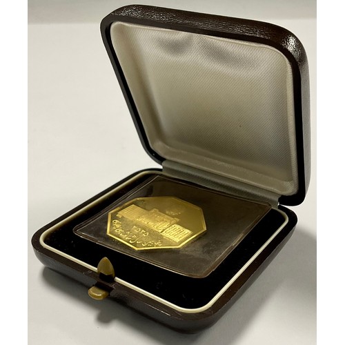 238 - An Iranian 22ct gold octagonal coin, The 50 Years Pahlavi Dynasty, Iranian date 2525, year of the co... 