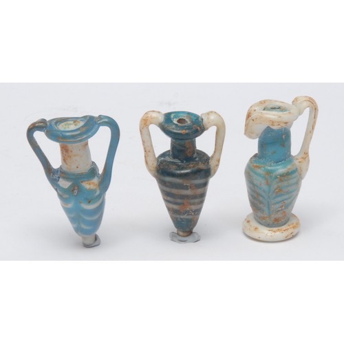 187 - Antiquities - a trio of Persian glassware scent bottles, of classical form, each 6cm high, cased, Qa... 