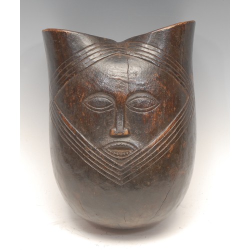 43 - Tribal Art - a Kuba vessel, carved in relief with a stylised face, 21cm high, Democratic Republic of... 