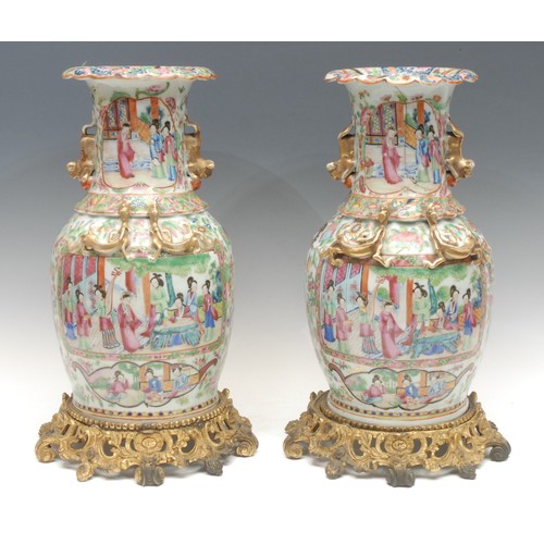 993 - A pair of Chinese Guangxu period famille rose vases, baluster form with scalloped rims, painted with... 