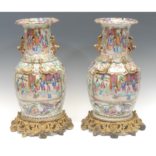 993 - A pair of Chinese Guangxu period famille rose vases, baluster form with scalloped rims, painted with... 