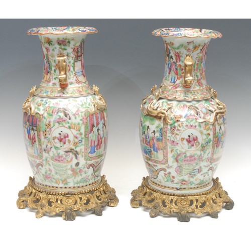 993 - A pair of Chinese Guangxu period famille rose vases, baluster form with scalloped rims, painted with... 