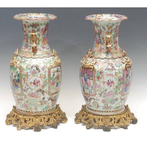 993 - A pair of Chinese Guangxu period famille rose vases, baluster form with scalloped rims, painted with... 