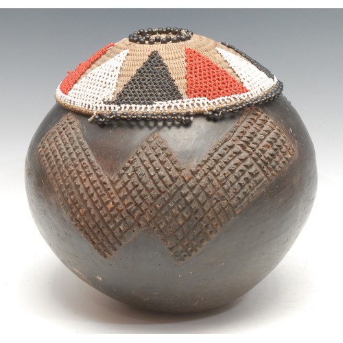 114 - A terracotta beer pot container, complete with a beaded cover, Zulu, early 20th century