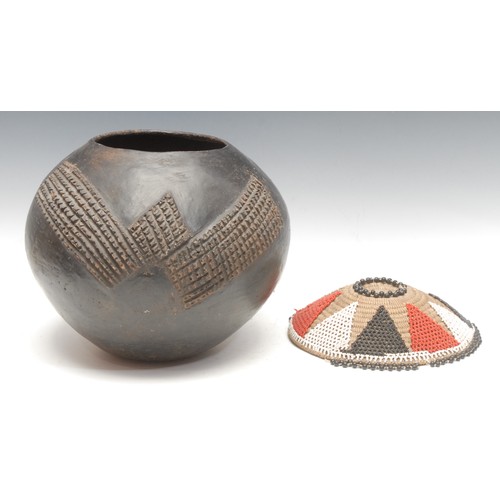 114 - A terracotta beer pot container, complete with a beaded cover, Zulu, early 20th century