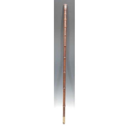 1035 - An early 20th century novelty gadget system walking stick, the bamboo cane enclosing a telescopic fi... 