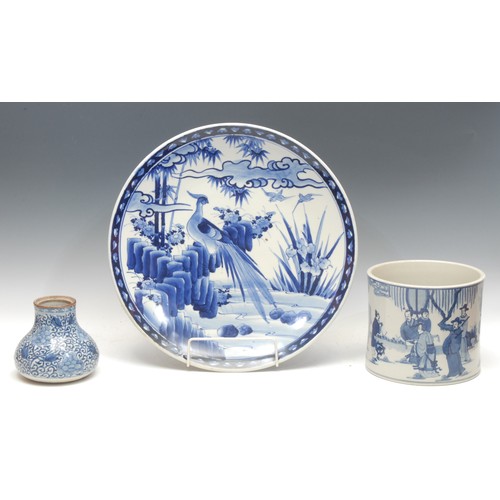 992 - A Japanese circular charger, painted in tones of underglaze blue, with a pheasant perched on a rocky... 