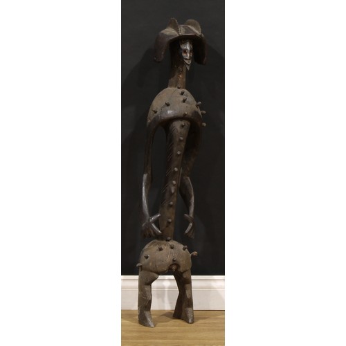 47 - Tribal Art - a large Mumuye figure, of typical elongated form, highly stylised features and coiffure... 