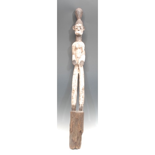 106 - Tribal Art - an Igbo Mmo Society figure, of slender proportions, decorated in white pigment, 100cm h... 