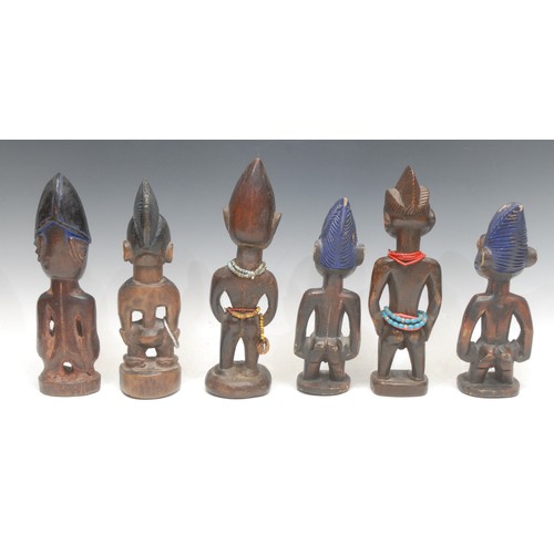 72 - Tribal Art - a pair of Yoruba Ibeji figures, typically carved, picked out in blue pigment, 24cm high... 