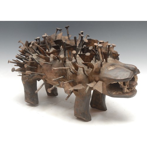 37 - Tribal Art - a Kongo Nkisi/Nkondi fetish dog, profusely adorned with nails and iron fragments, 52cm ... 