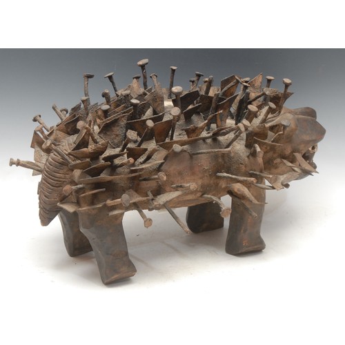 37 - Tribal Art - a Kongo Nkisi/Nkondi fetish dog, profusely adorned with nails and iron fragments, 52cm ... 