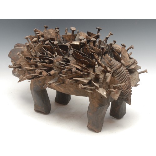 37 - Tribal Art - a Kongo Nkisi/Nkondi fetish dog, profusely adorned with nails and iron fragments, 52cm ... 