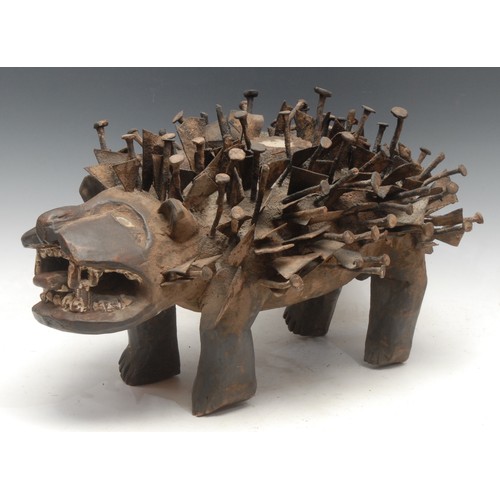 37 - Tribal Art - a Kongo Nkisi/Nkondi fetish dog, profusely adorned with nails and iron fragments, 52cm ... 