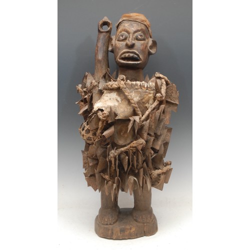 38 - Tribal Art - a Kongo Nkisi/Nkondi fetish figure, depicted with arm raised, typically adorned with ir... 