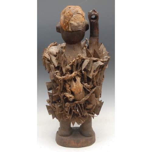 38 - Tribal Art - a Kongo Nkisi/Nkondi fetish figure, depicted with arm raised, typically adorned with ir... 