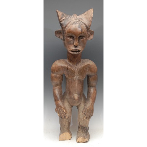 18 - Tribal Art - a Chokwe male figure, he stands, 66cm high, Angola