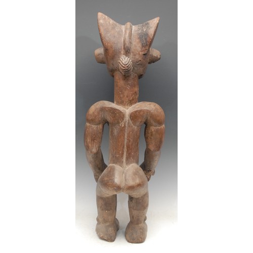 18 - Tribal Art - a Chokwe male figure, he stands, 66cm high, Angola