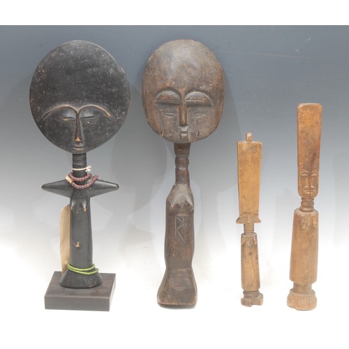 102 - Tribal Art - an Ashanti fertility doll, elongated features, 32cm long, Ghana; another, similar; othe... 