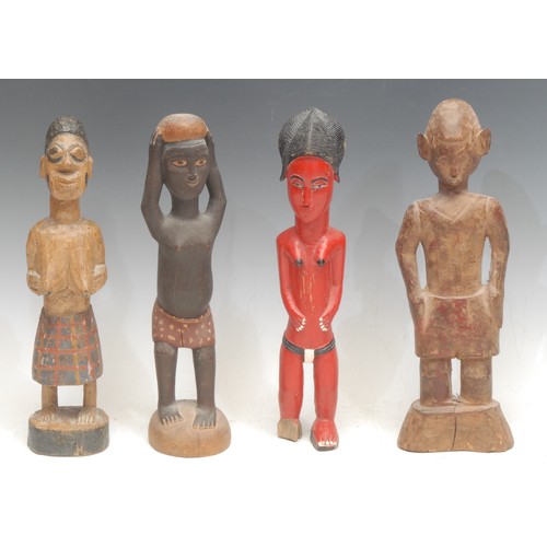 7 - Tribal Art - a Baule colon figure, standing, wearing a spotted red garment, 28cm high, Ivory Coast, ... 