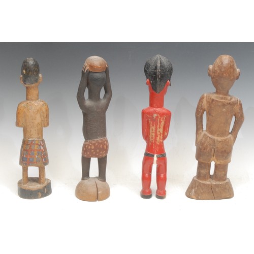 7 - Tribal Art - a Baule colon figure, standing, wearing a spotted red garment, 28cm high, Ivory Coast, ... 