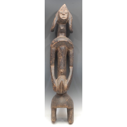 66 - Tribal Art - a Mumuye figure, of typical elongated form, stylised head with abstract features and ov... 