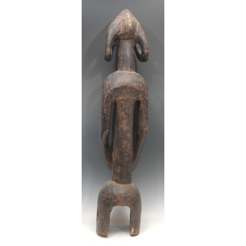 66 - Tribal Art - a Mumuye figure, of typical elongated form, stylised head with abstract features and ov... 