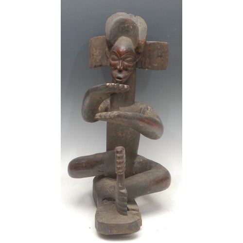 17 - Tribal Art - a Chokwe figure, Chibinda Ilunga, depicted seated, 46cm high, Angola