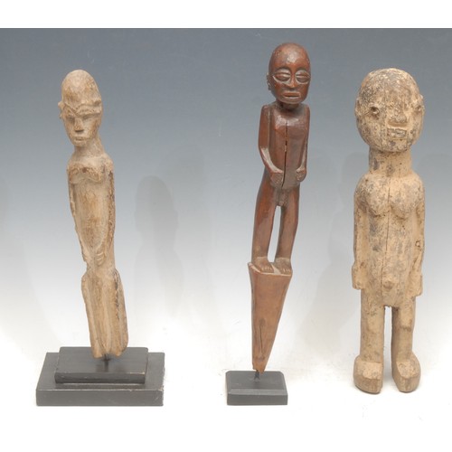 52 - Tribal Art - a Lobi figure, 33cm high, Burkina Faso; another, 29cm high, collector's display stand; ... 