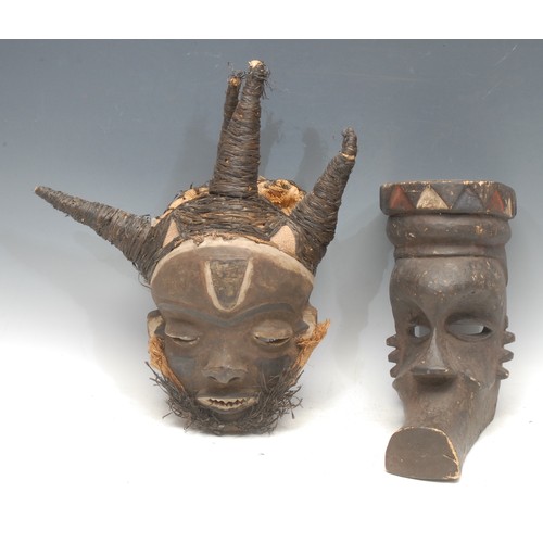 73 - Tribal Art - a Pende Mbuya mask, bound and adorned in fibrous twine, 38cm high, Zaire; another (2)