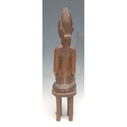 78 - Tribal Art - a Senufo maternity figure, depicted seated on a stool, 46cm high, Ivory Coast