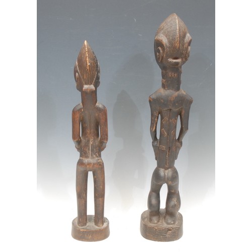 10 - Tribal Art - a Baule figure, depicted standing, his hands to his slender midriff, 50cm high, Ivory C... 